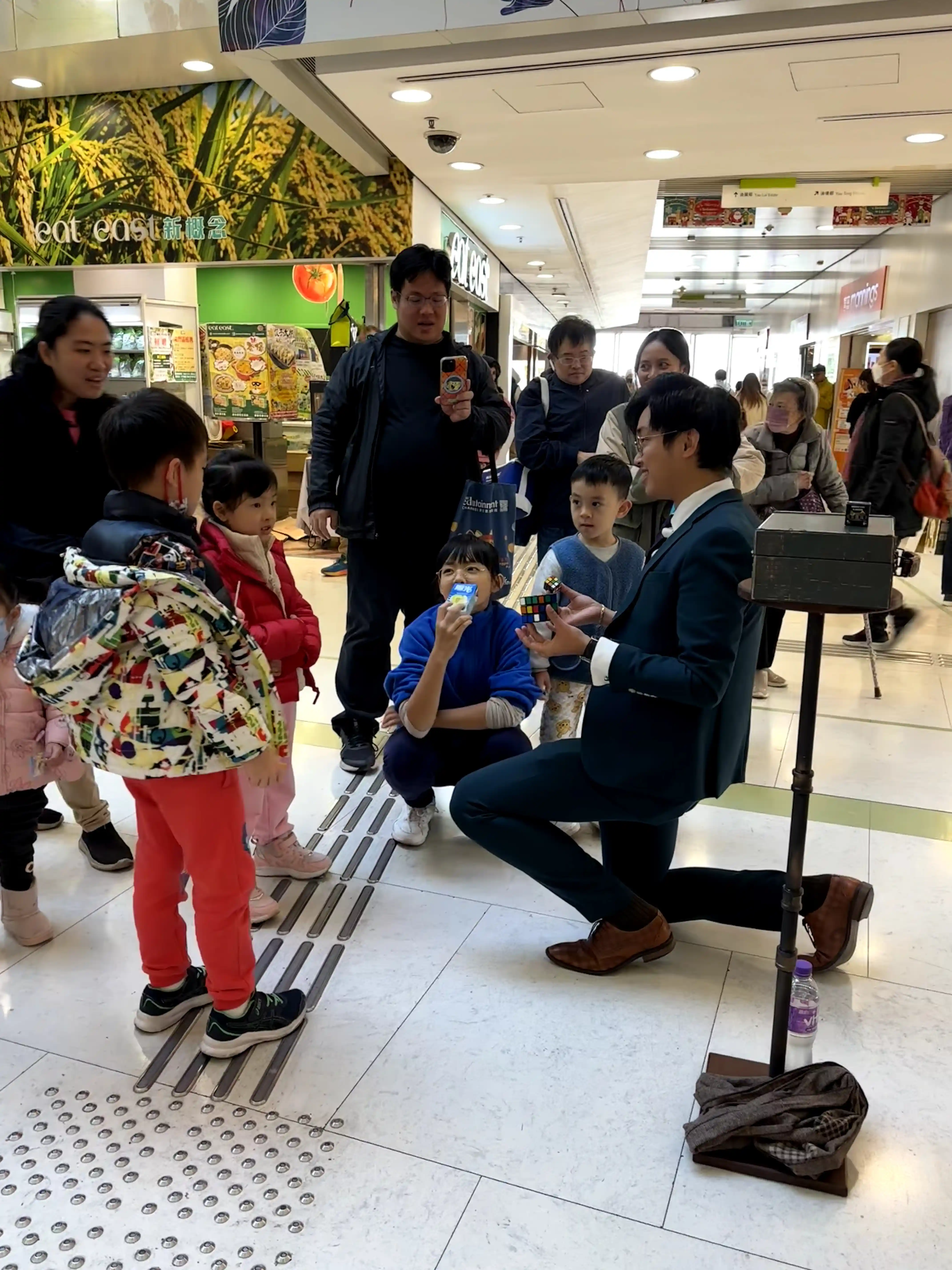 Crowd gathered around a magician at a party