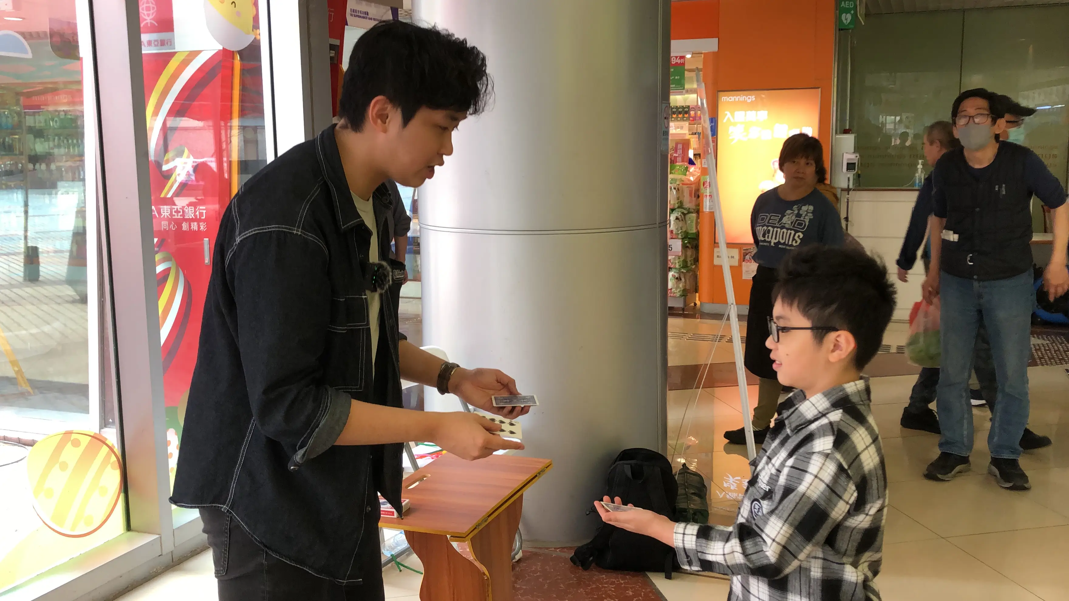 Magician interacting with shoppers in a mall