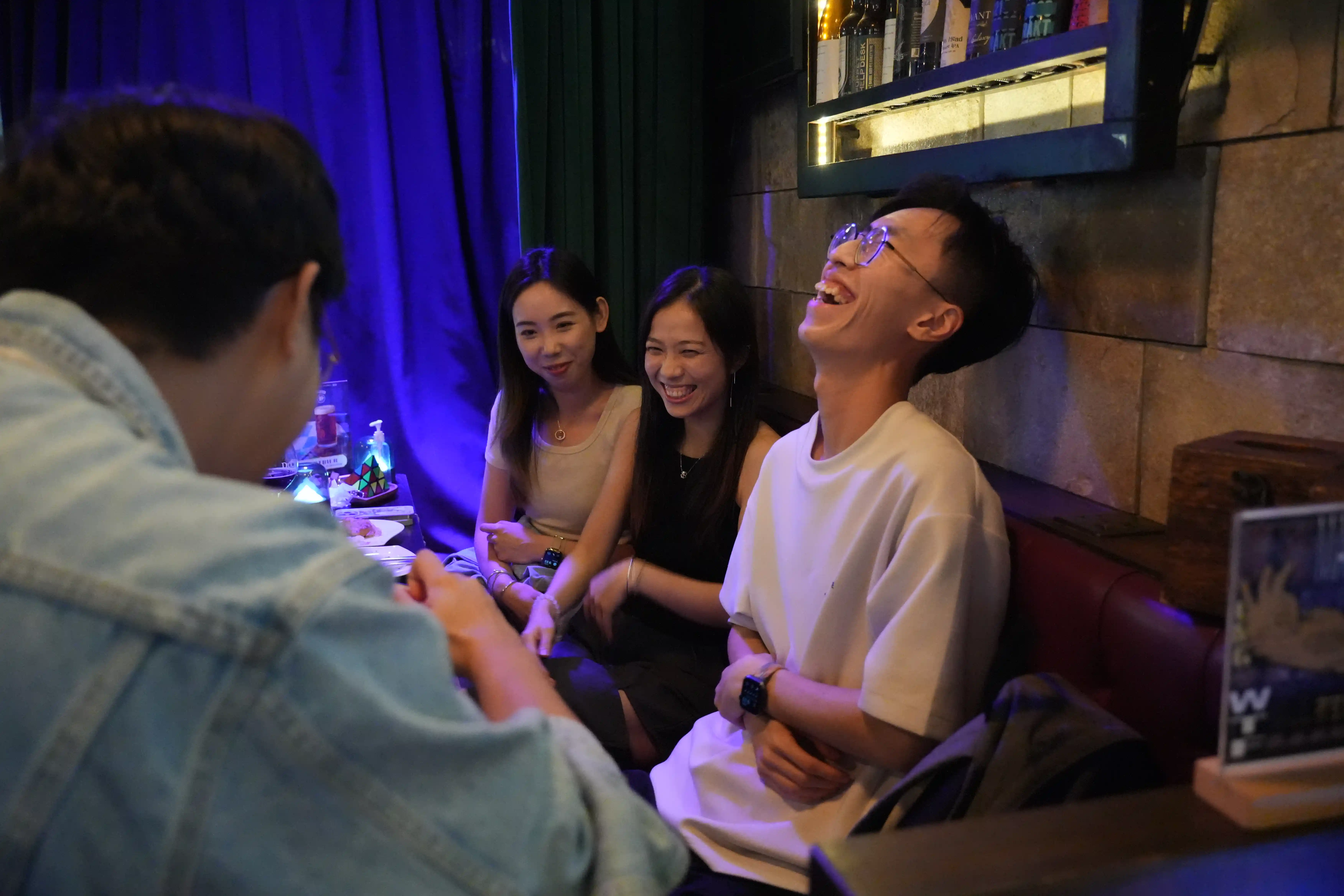 Guests laughing during table hopping magic